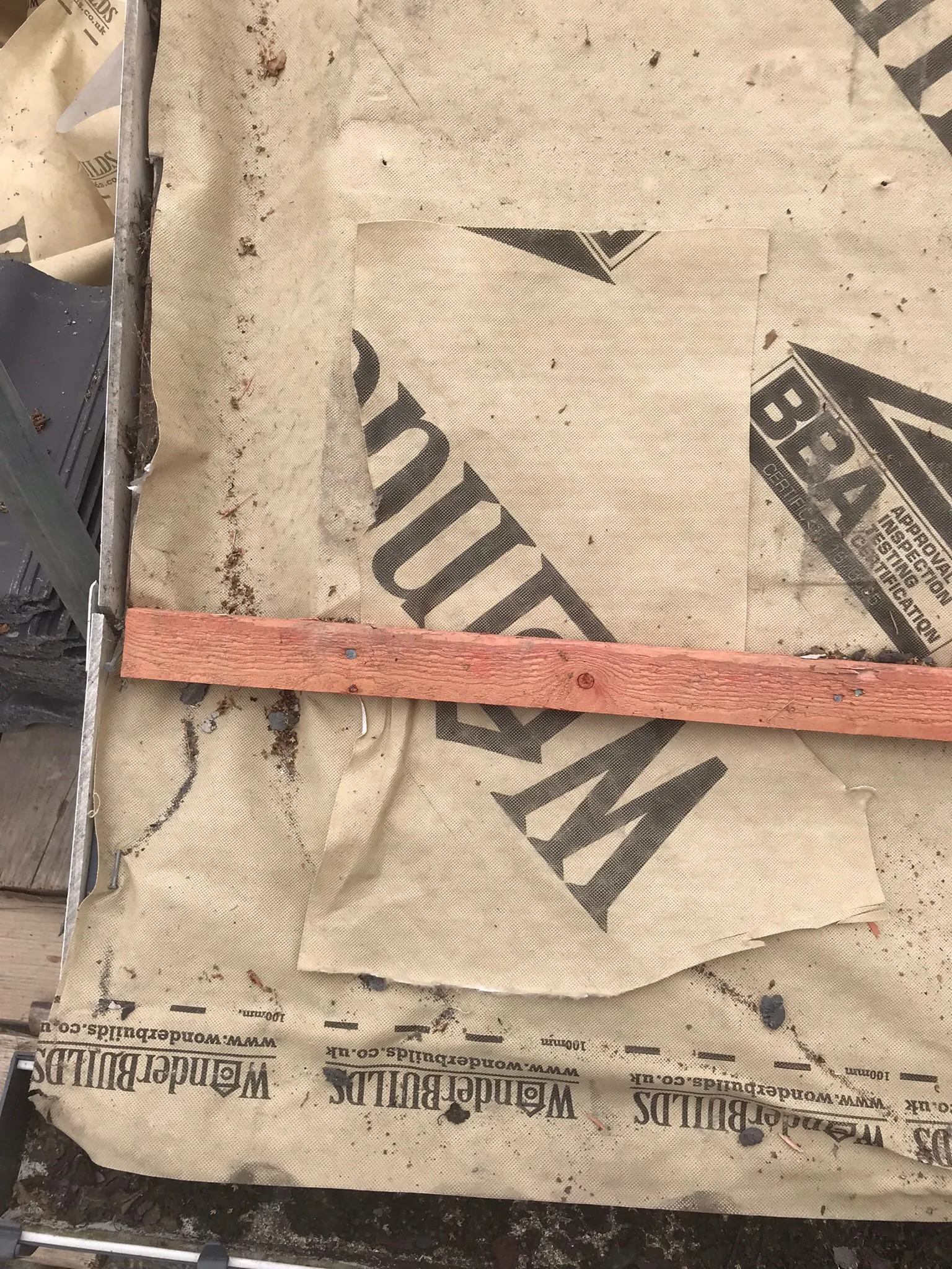 Close-up of roofing underlayment with a timber batten installed on a roof.