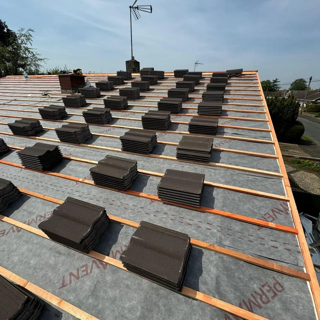 New roof installation showing underlayment, battens and tiles ready for fitting by Century Roofing and Building