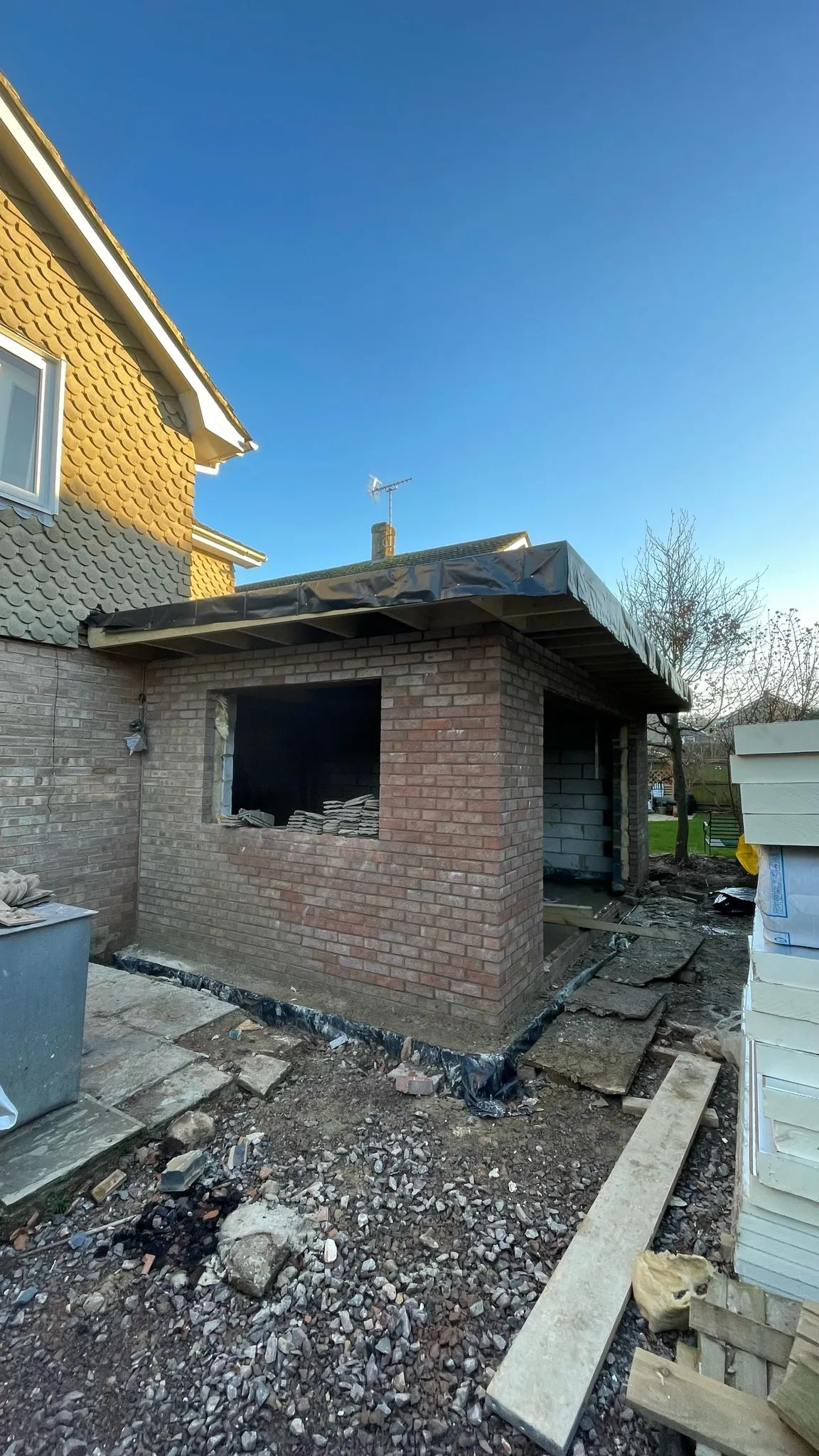 A single-storey brick home extension under construction in Cheltenham