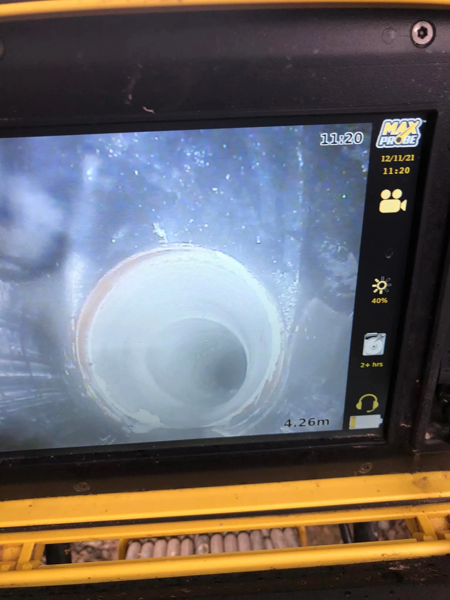 Screen showing live CCTV drain camera inspection inside a pipe.