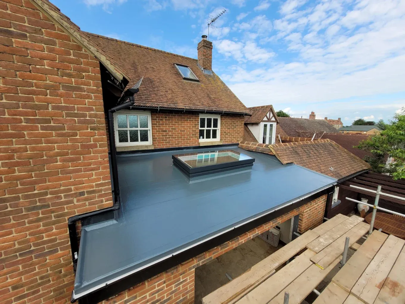 Newly installed grey flat roof with rooflight by Ox Roofing