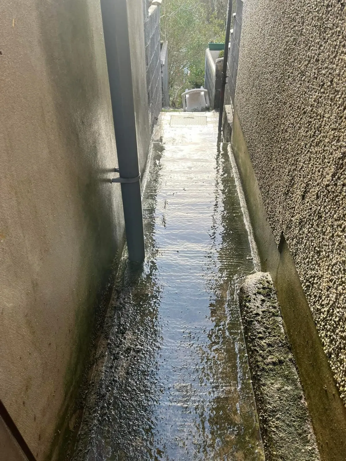 Flooded alleyway from blocked drain