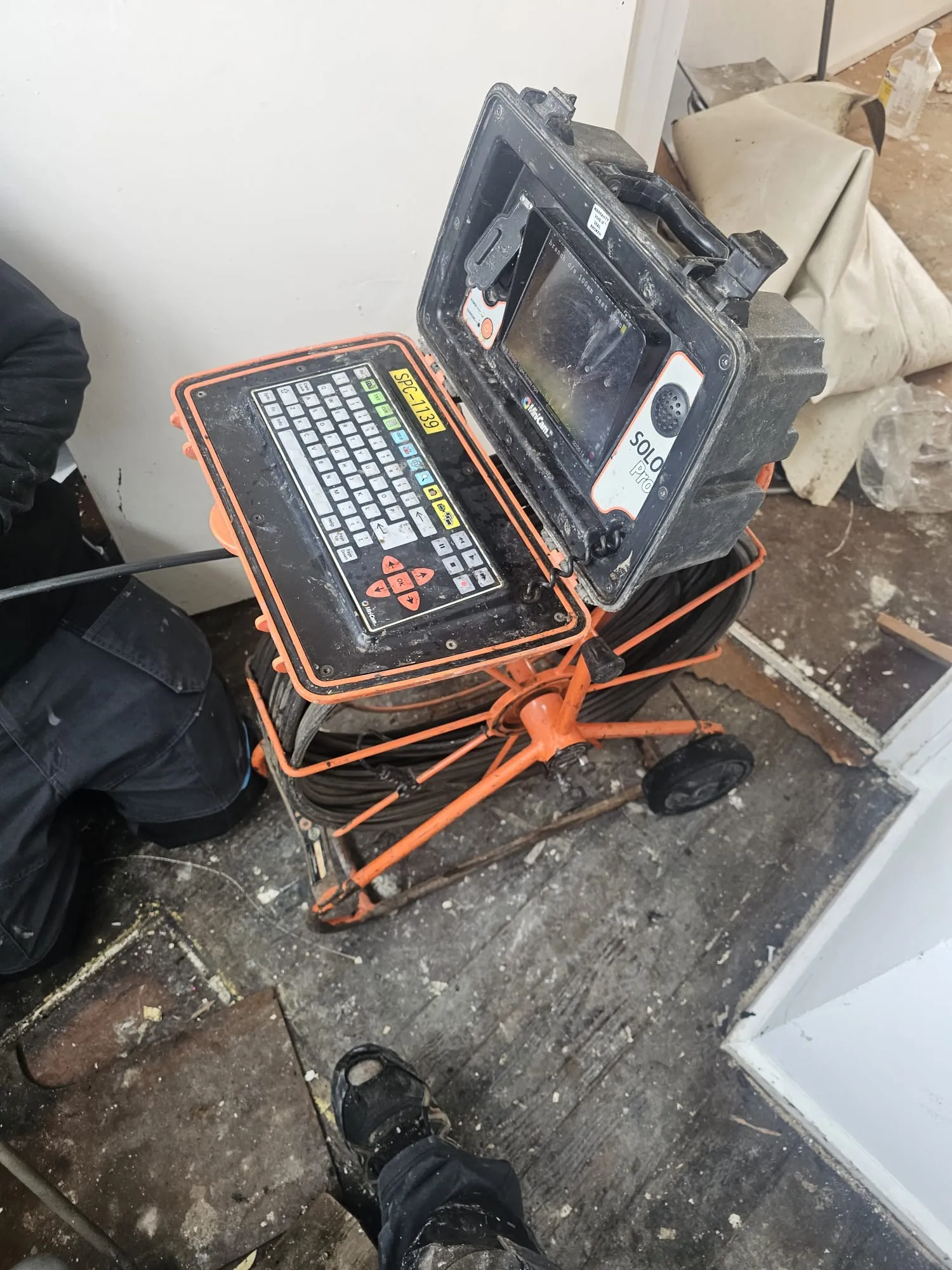 An engineer operating a SoloPro CCTV drain survey camera system to diagnose drainage issues.