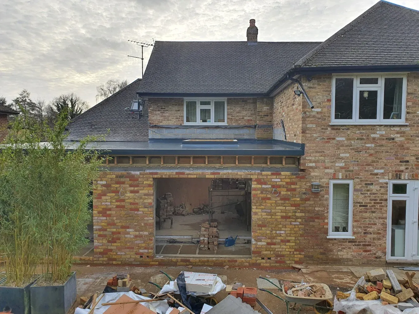 New flat roof being installed on a house extension during construction.