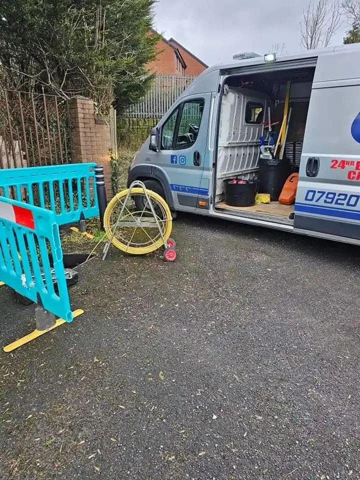 Worsley Drains van on-site with professional drainage equipment including a CCTV or jetting hose reel, ready for service.