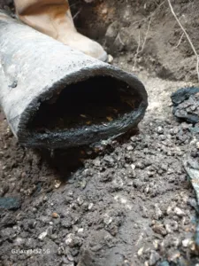 Severely blocked drain pipe showing internal sludge and degradation, likely requiring repair or replacement.