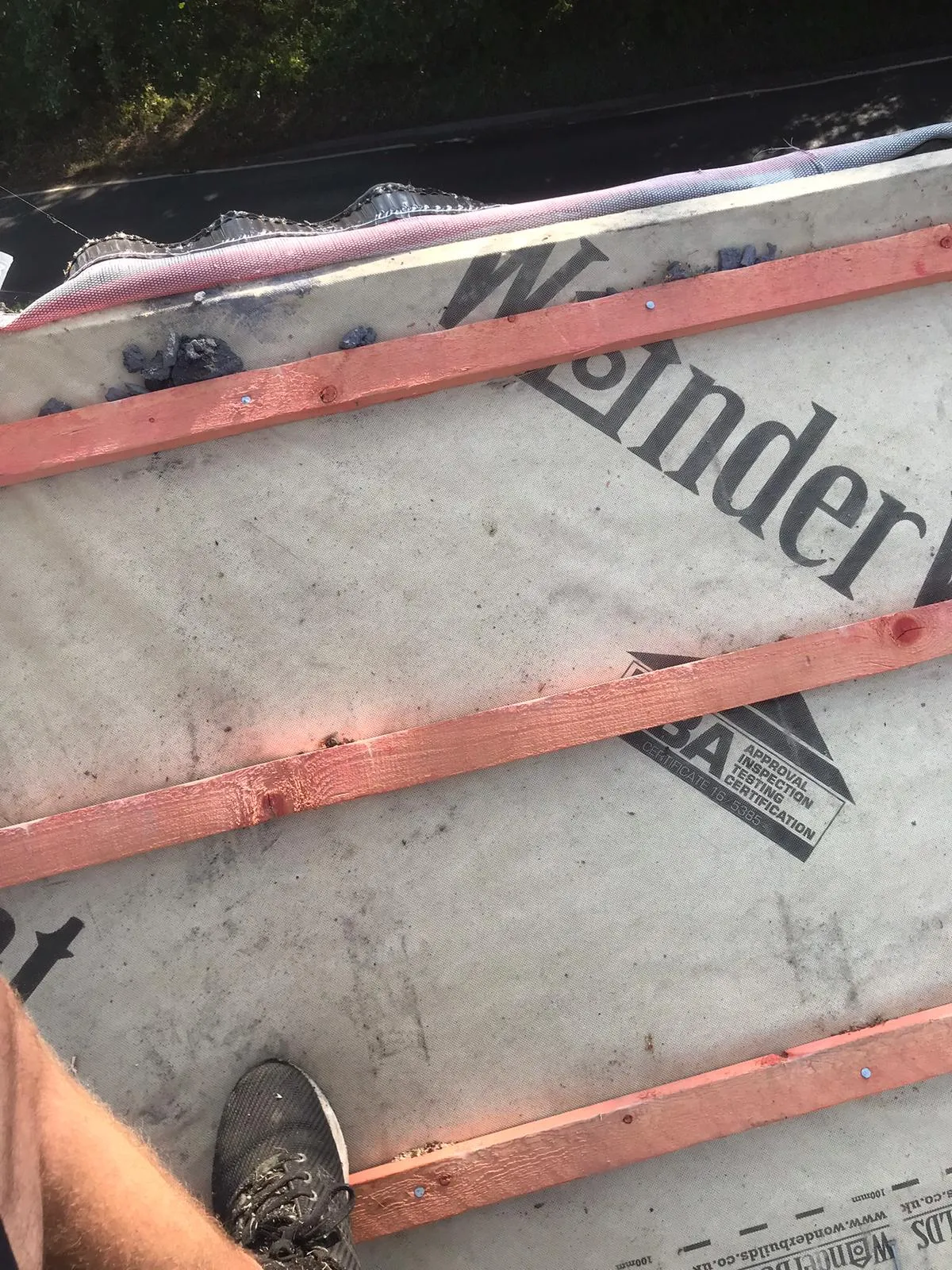 Roof under construction with roofing membrane and wooden battens