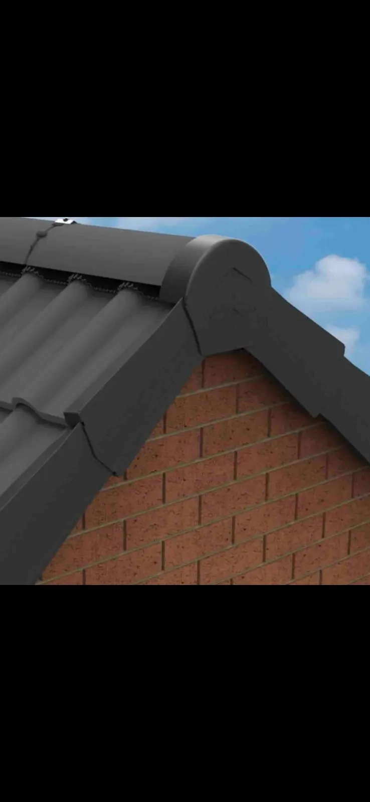 Close-up of a grey dry verge system installed on a roof's gable end, with brickwork visible