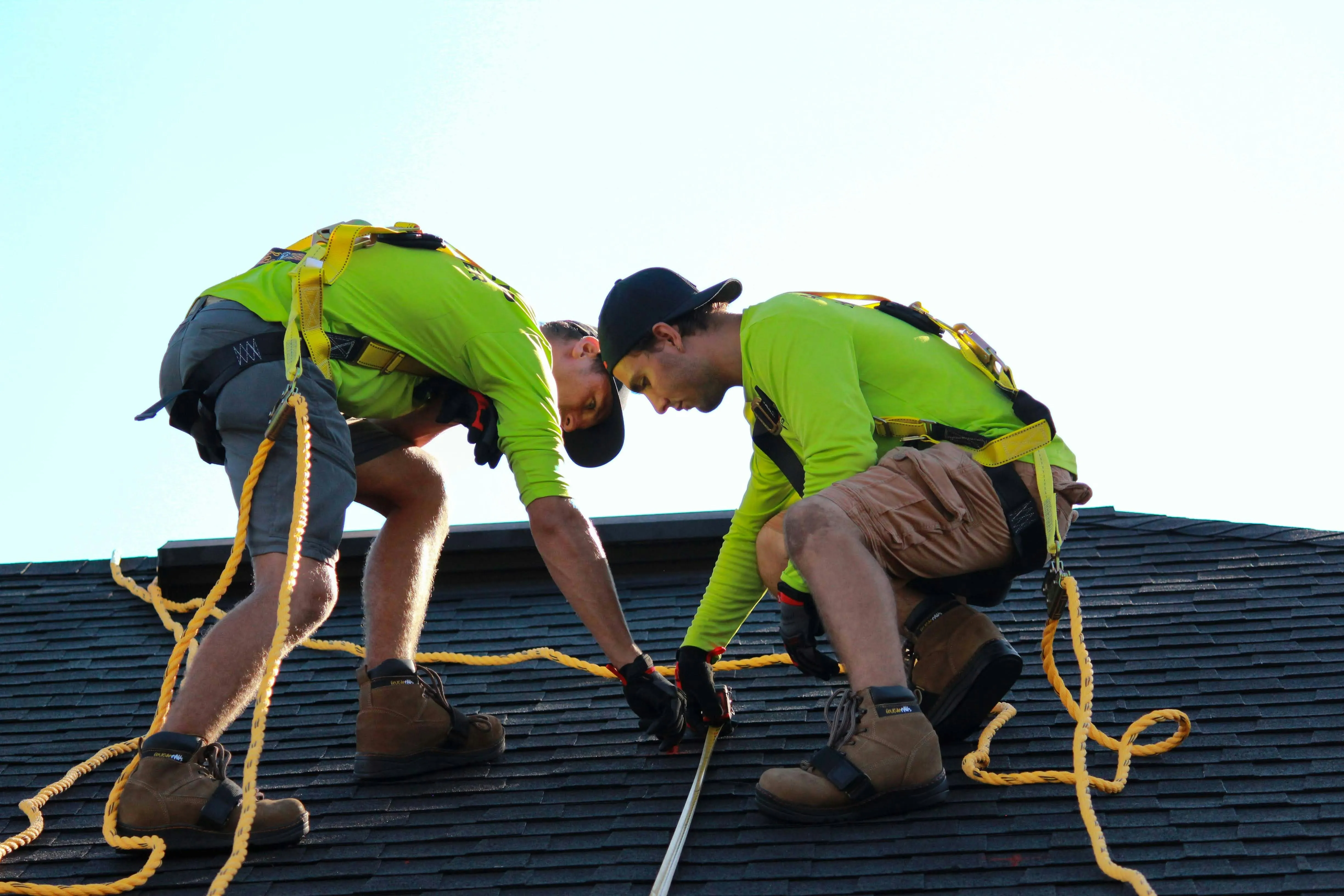 Foster and Son roofers installing tiles on a new pitched roof, demonstrating safe and professional workmanship.