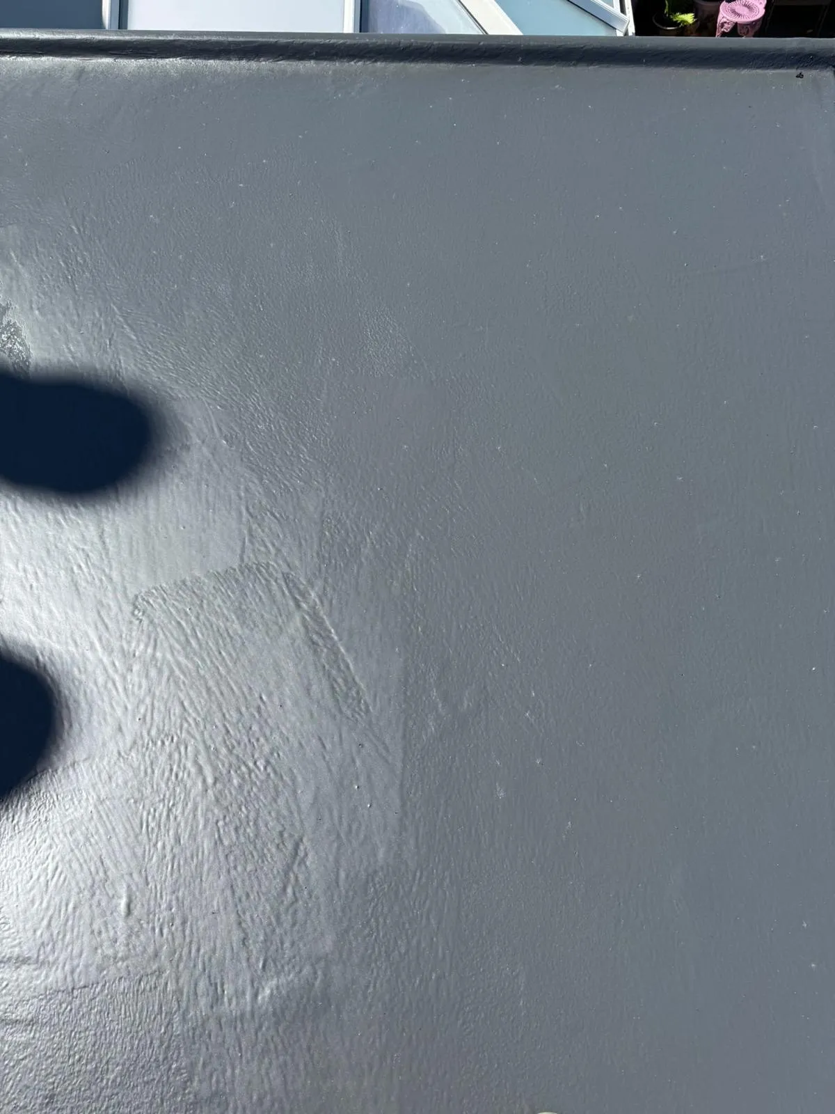 Close-up of a new grey GRP fibreglass flat roof.