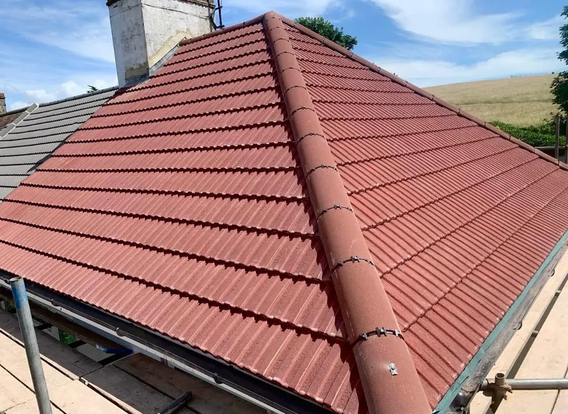 New red tiled roof installation or re-roofing on a house by Devon and Cornwall Roofing.