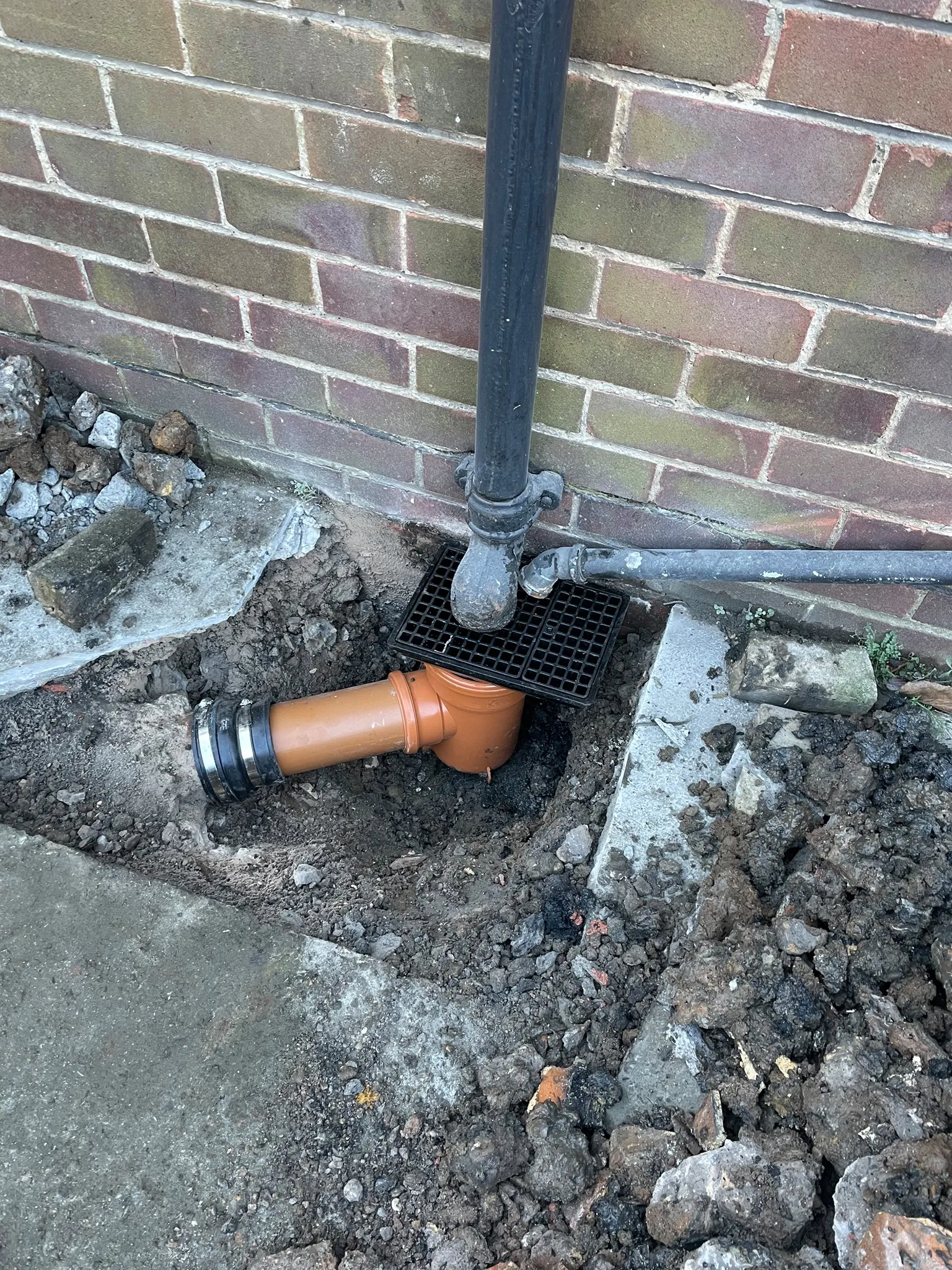 New orange drainage pipe and grid installed by Insta Drain