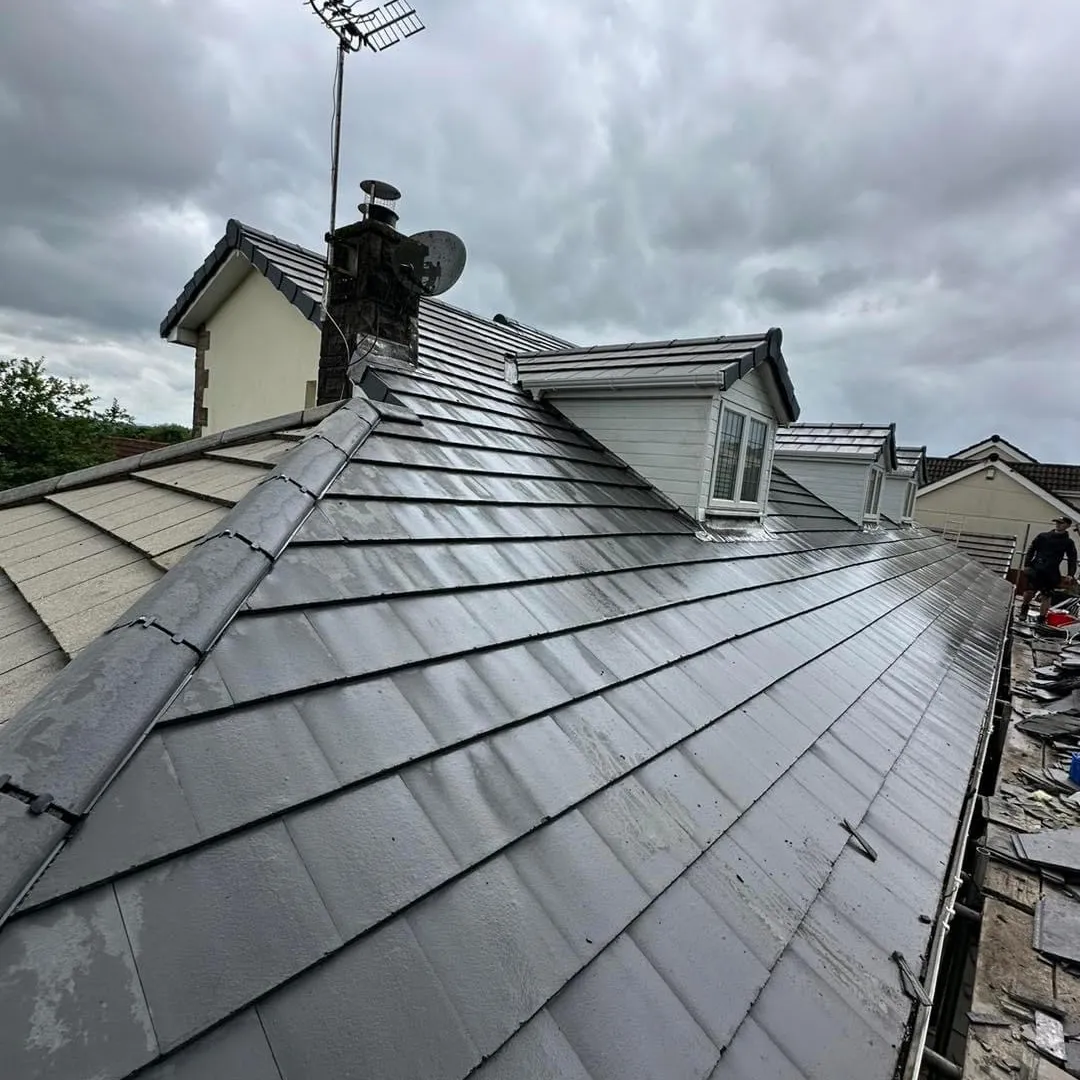 Expert roof tiling and new roof installation on a house with dormers in Kent by Century Roofing and Building.