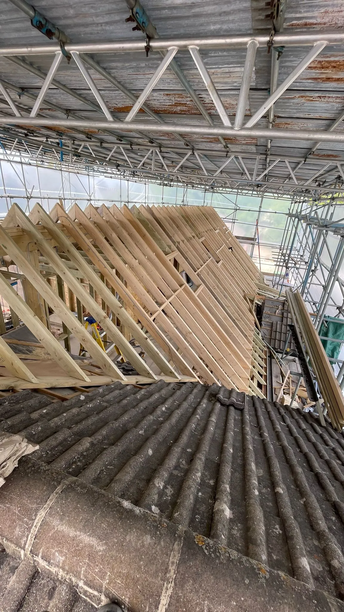 Bespoke timber roof trusses and rafters being installed during a home renovation project by DP Carpentry and Building LTD.