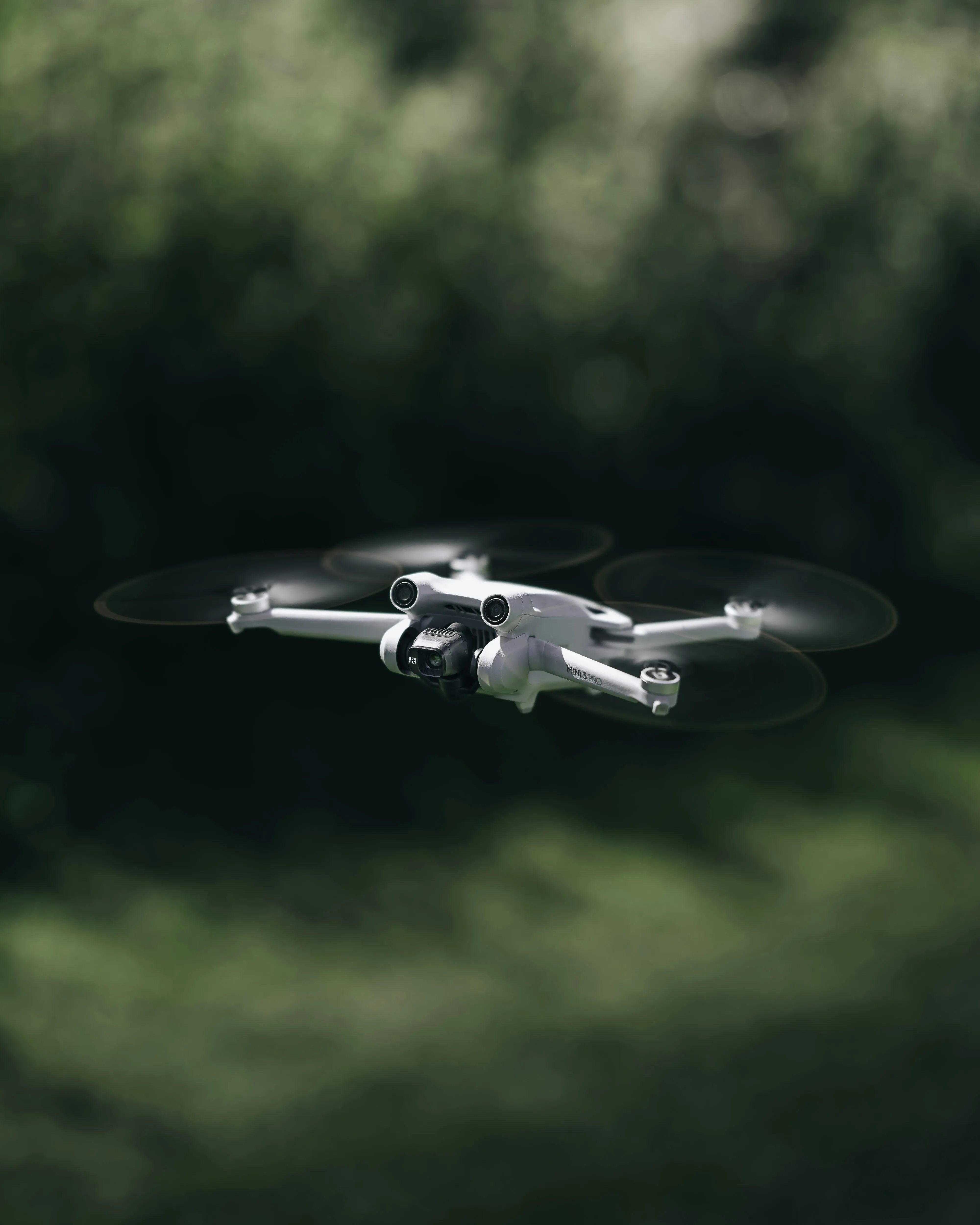 A white DJI Mini 3 Pro drone flying, representing our professional drone roof survey services for comprehensive property inspections.