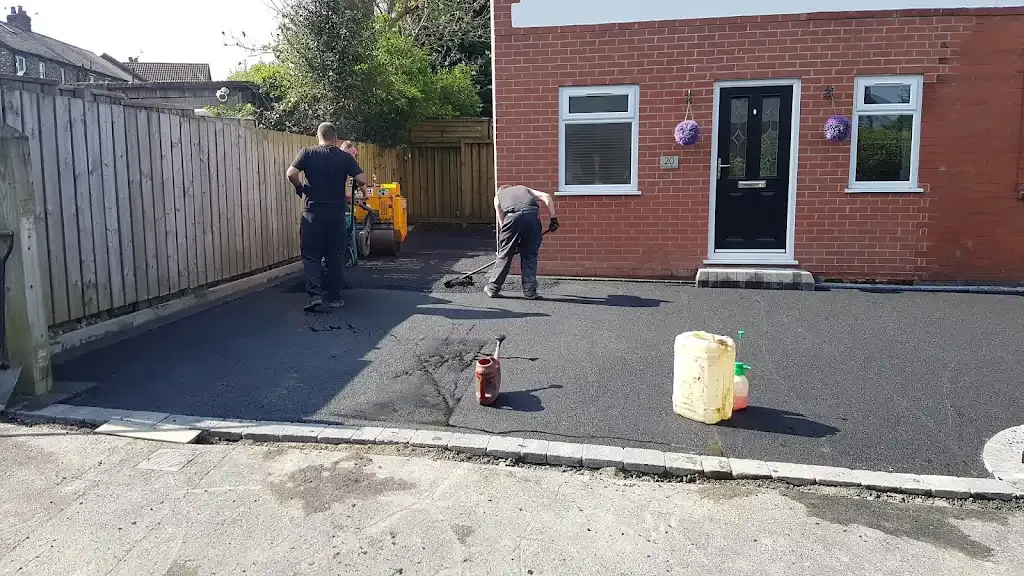 Workers installing a tarmac driveway