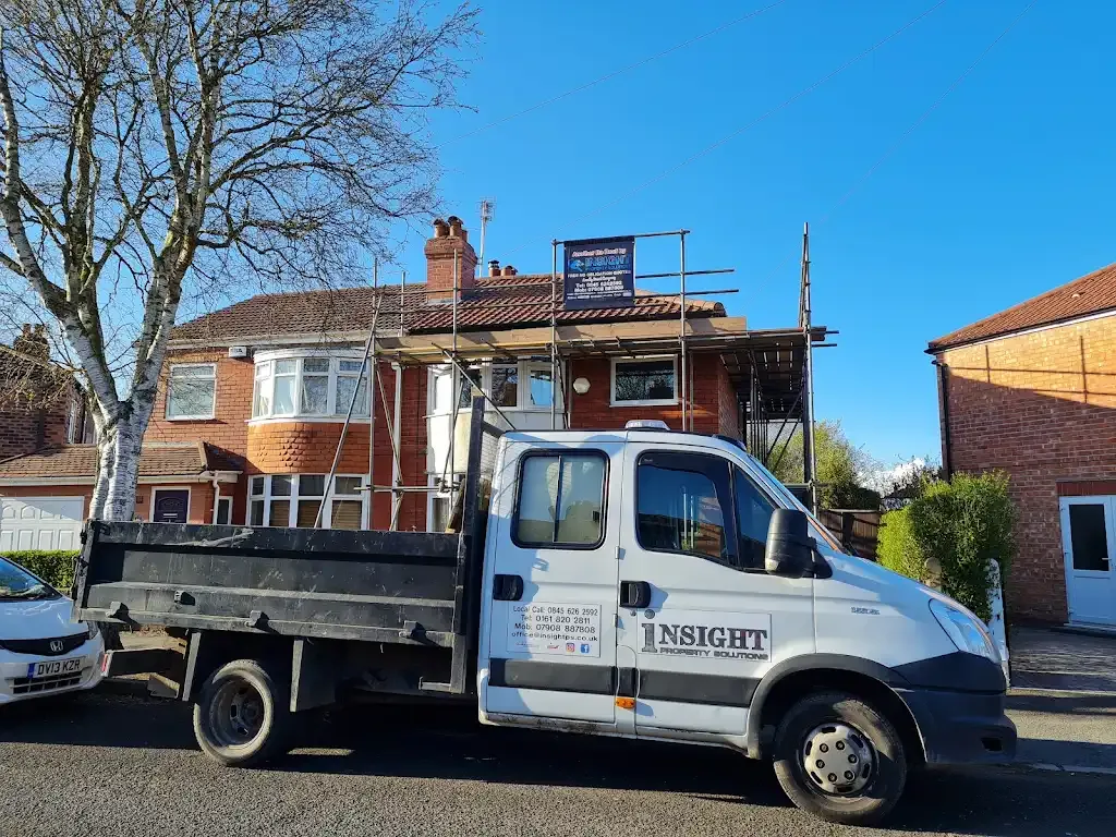 Insight PS company truck parked in front of a house with scaffolding for roofing repairs or replacement.