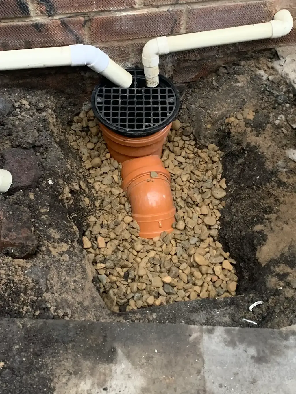 A close-up of a professional drain excavation and pipe installation in Durham.
