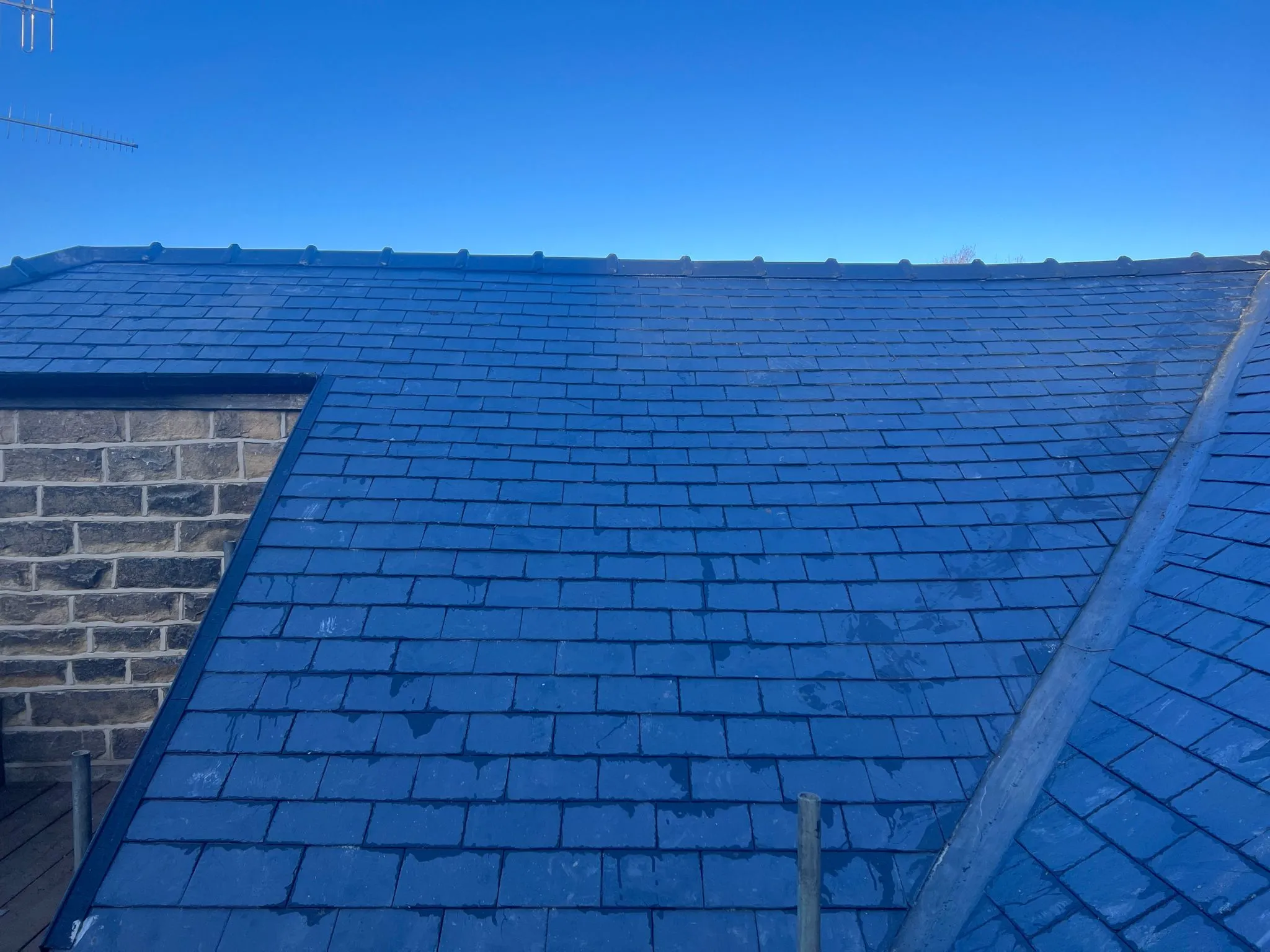 Newly installed or repaired slate roof tiles on a pitched roof in Sheffield or the Peak District by Alliance Roofing Services