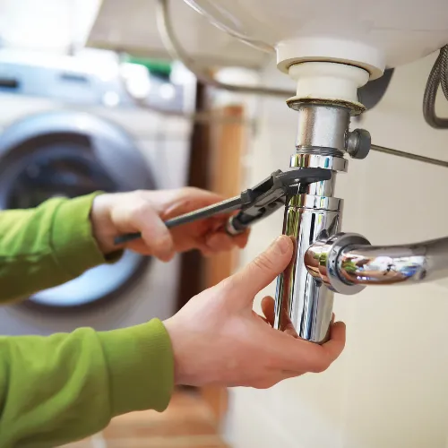 Person working on a sink drain