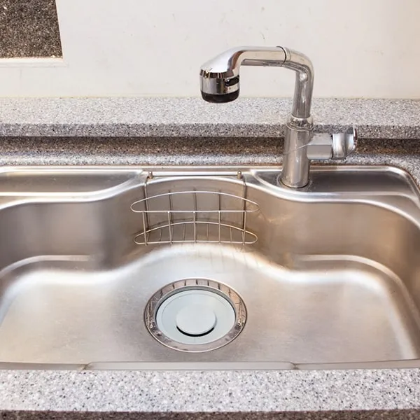 A clear picture of a kitchen sink, a common location for drain issues like blockages or requiring cleaning.