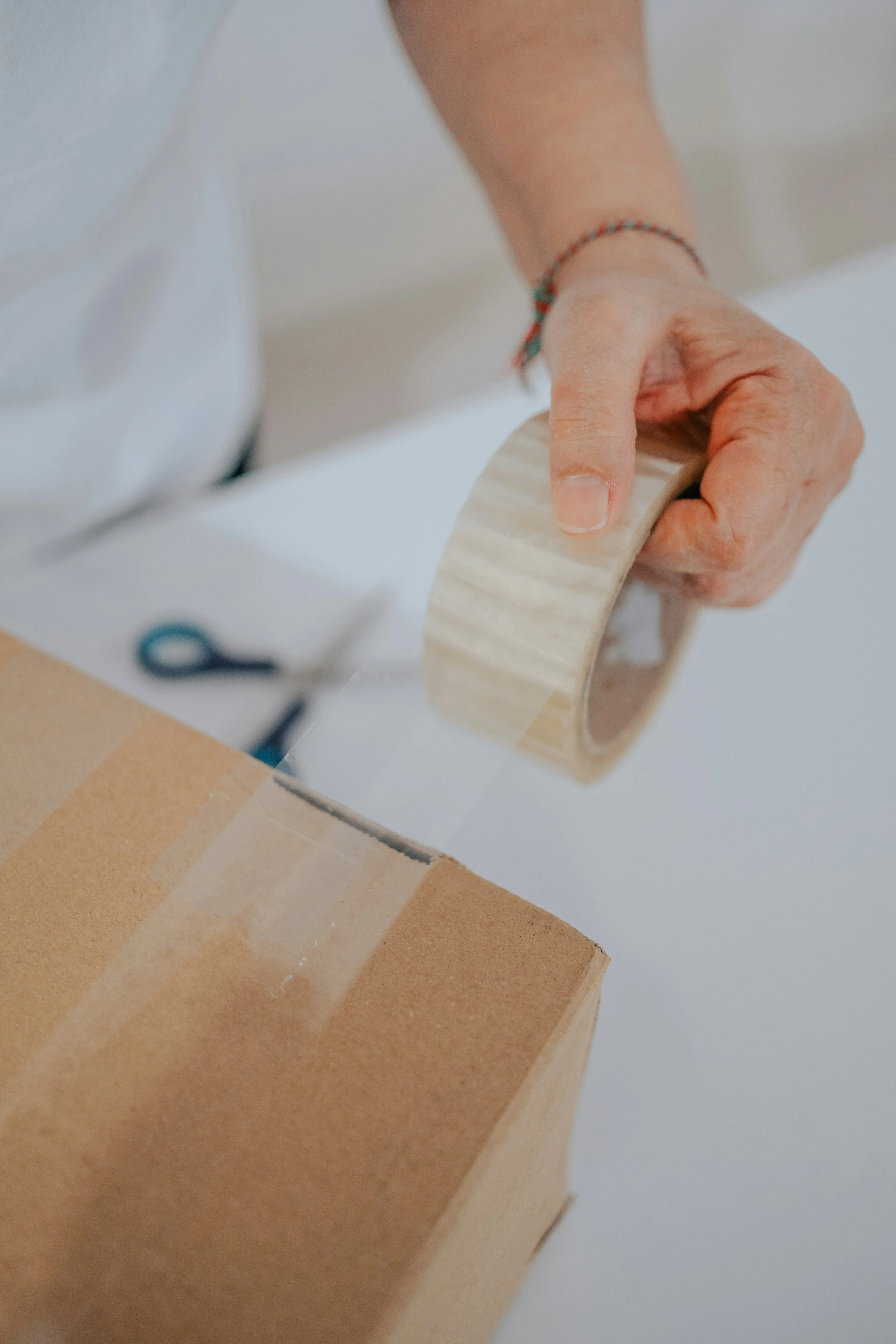 London Moving Services team member taping a moving box as part of our professional packing service.