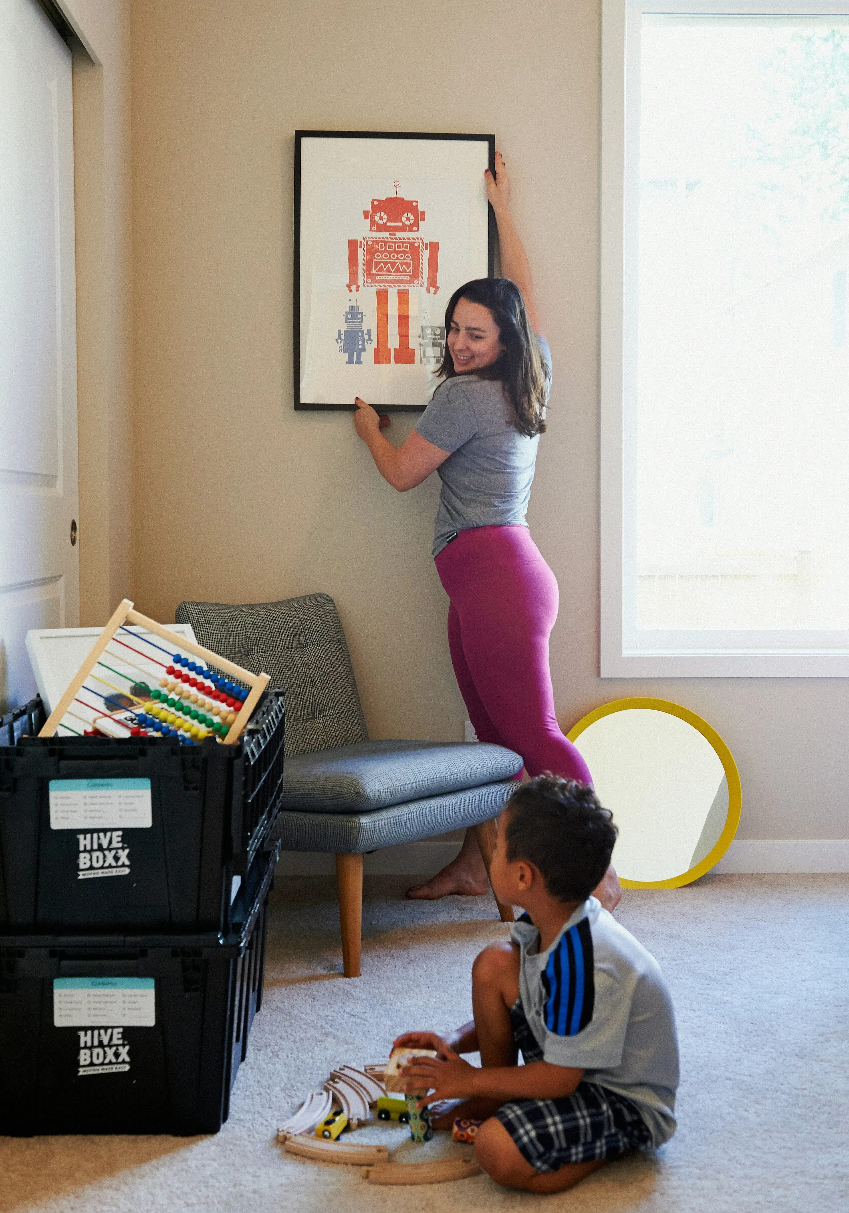 Mother and son unpacking and settling into a new home after a smooth residential removal service from London.