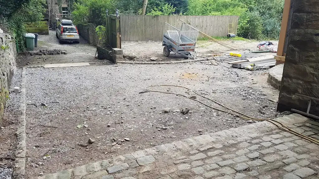 Photo showing groundwork preparation with gravel base for a new driveway installation.