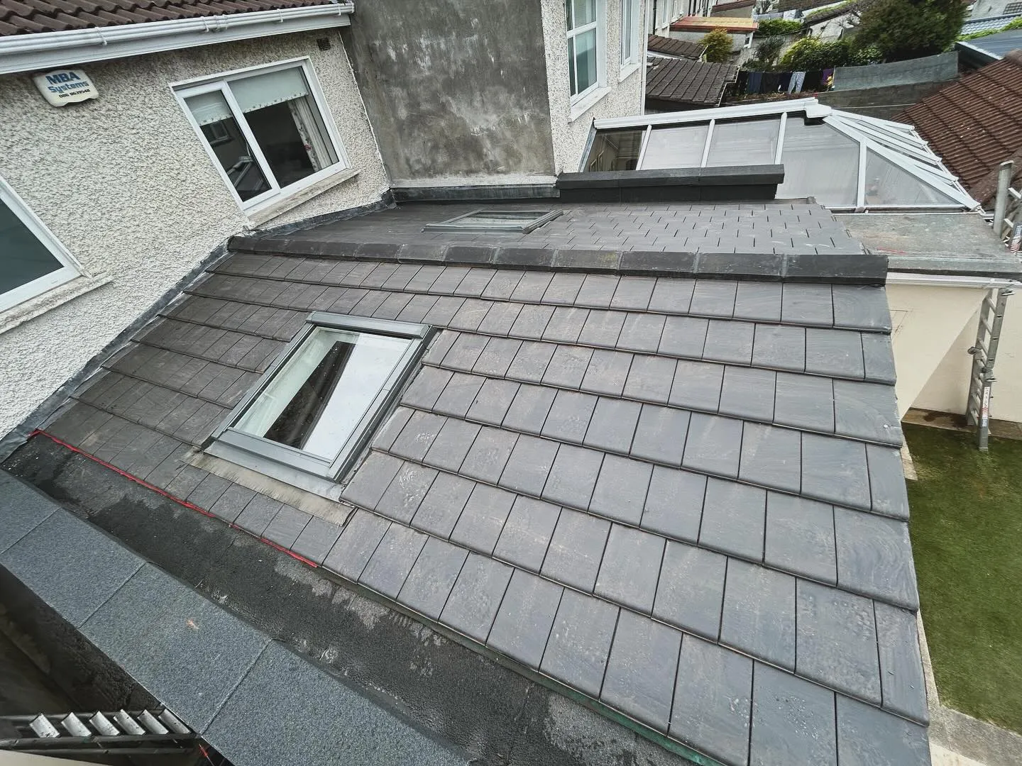 Newly installed tiled pitched roof with Velux windows by Toptile Roofing Specialists Ltd.