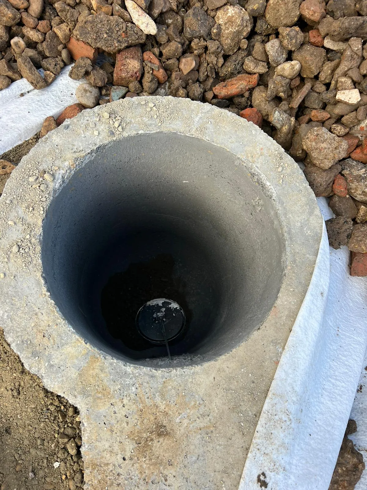 New concrete drainage inspection chamber under installation.