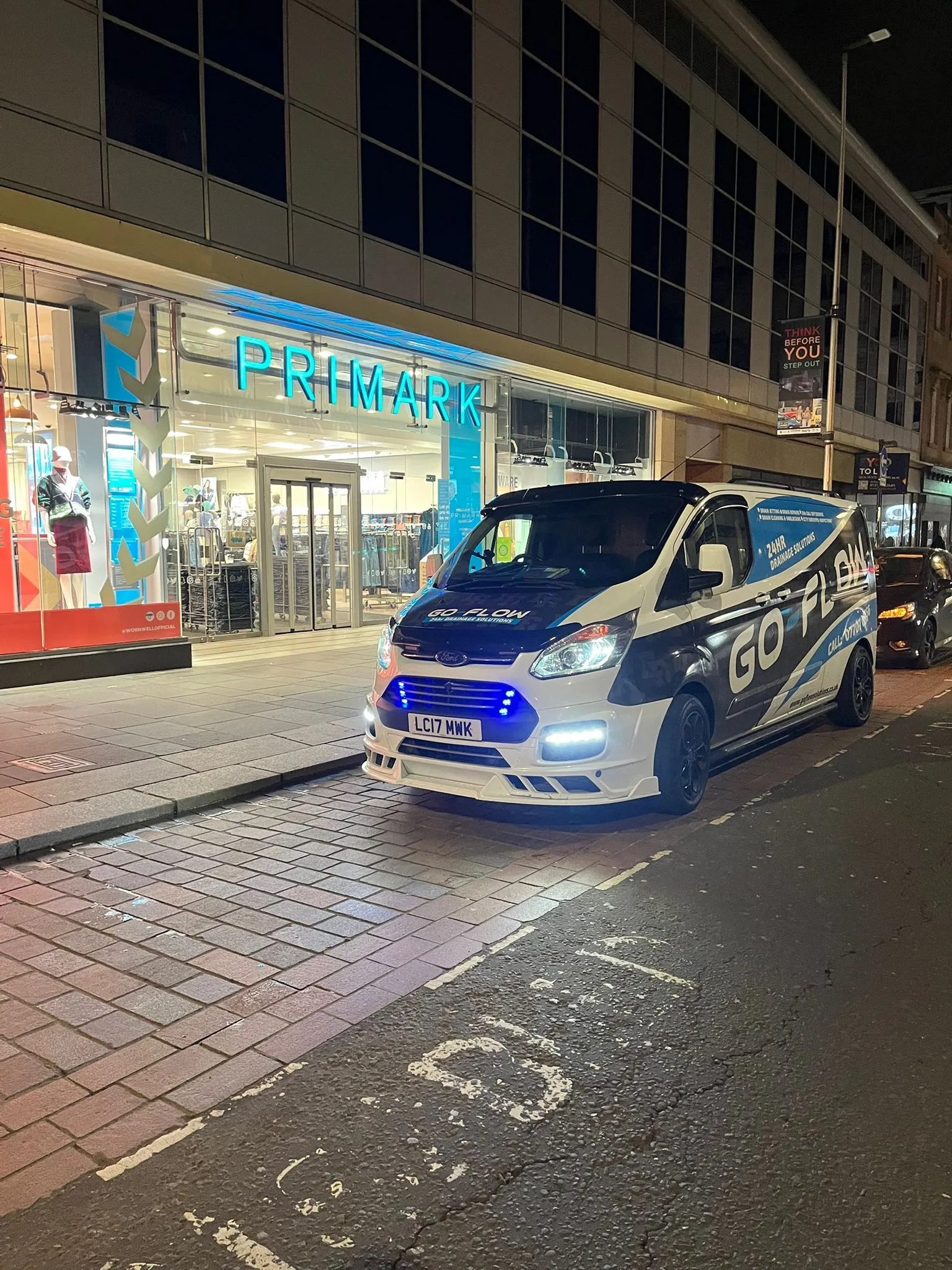 Go-Flow Drainage Solutions LTD van parked on a street at night