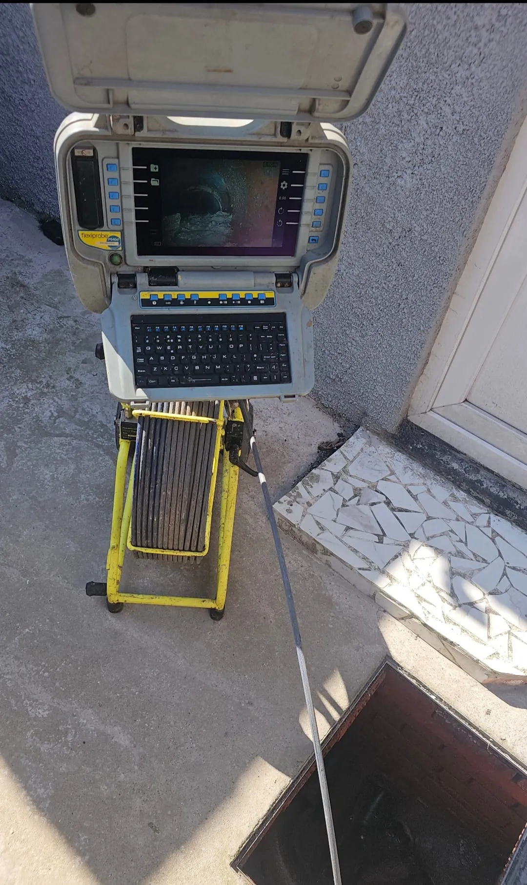CCTV drain survey camera unit checking an open manhole