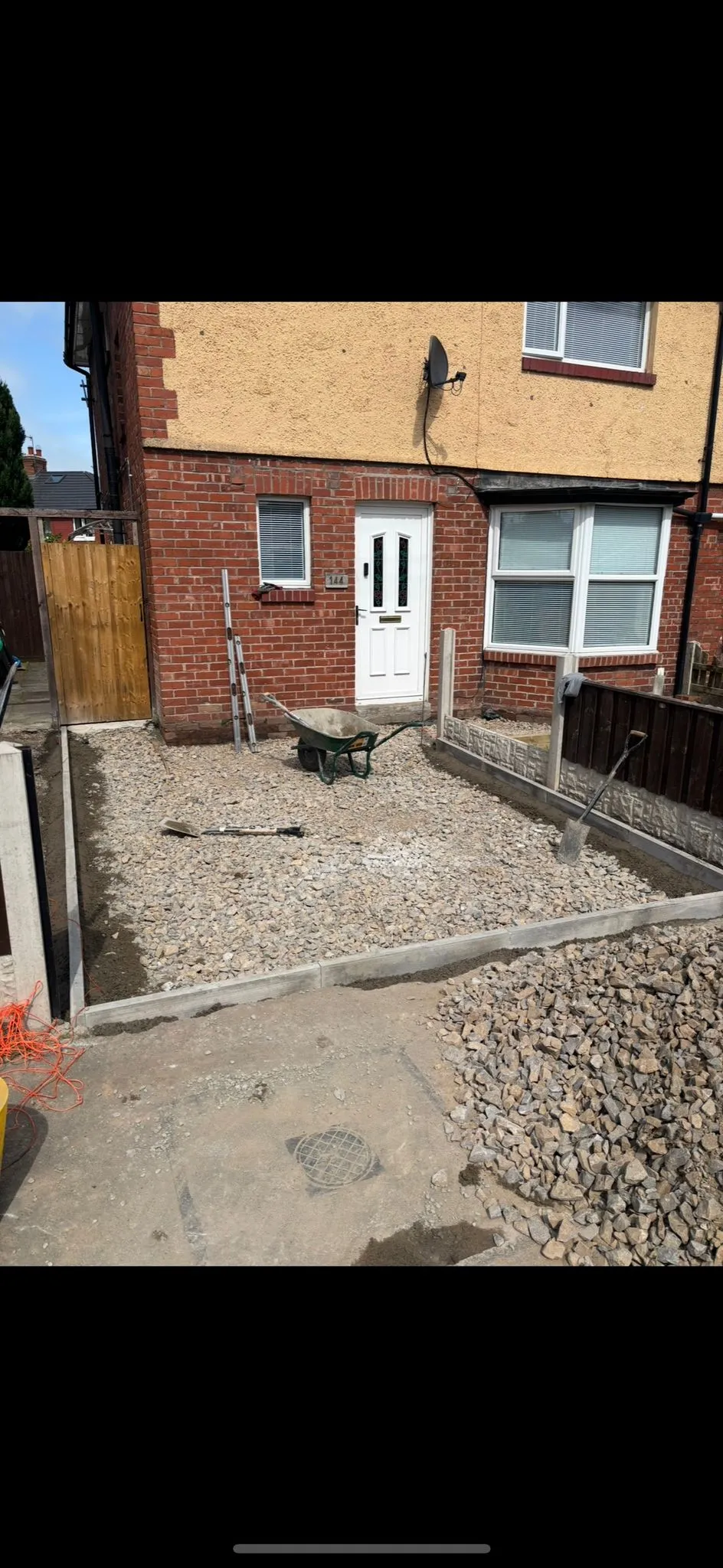 Groundwork in progress for a new residential driveway or paved area with aggregates and kerbstones.