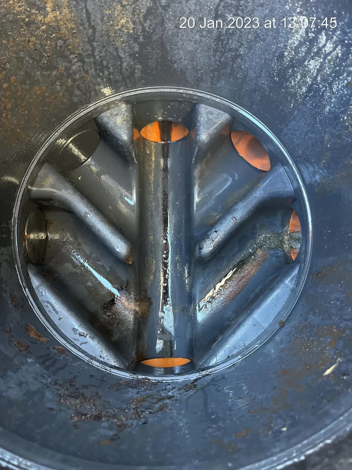 Close-up view inside a plastic drainage system component.