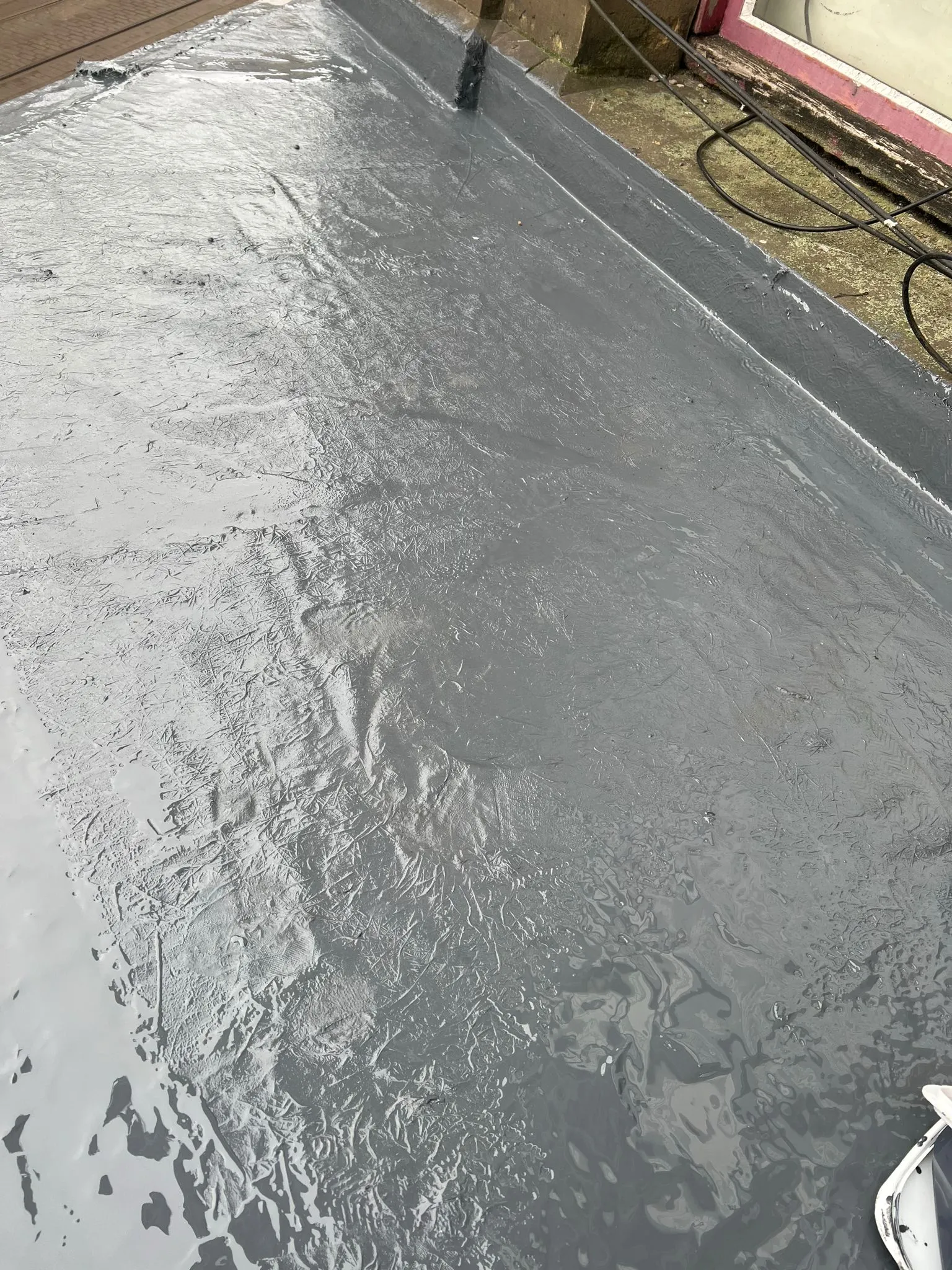 Applying waterproof coating to a flat roof