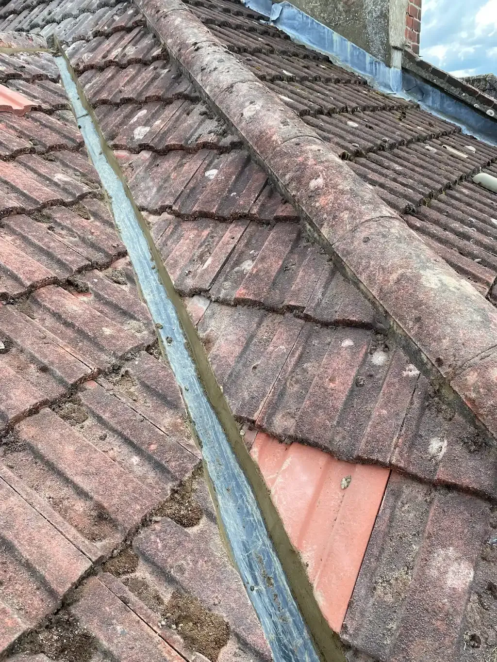 Close up of tiled roof valley with lead flashing