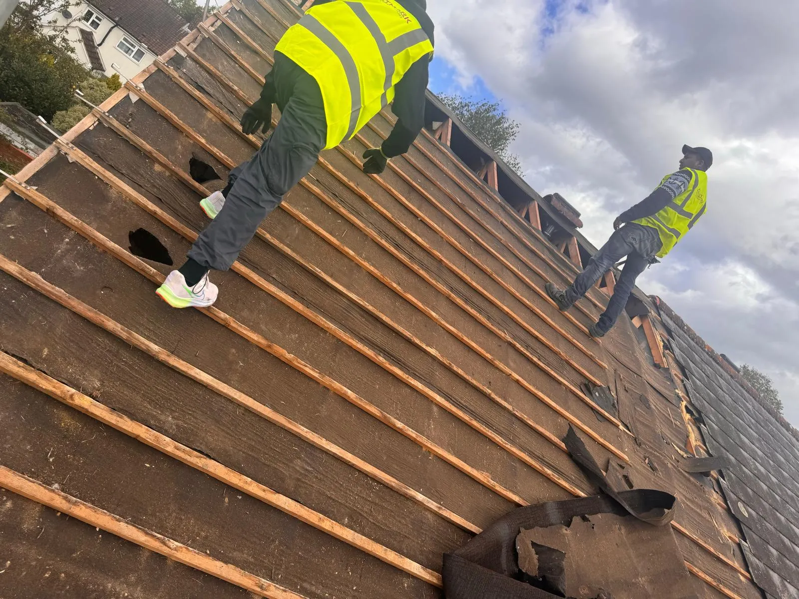 Trustmark Roofing team installing a new pitched roof, showing battens and underlay, highlighting professional roof construction.