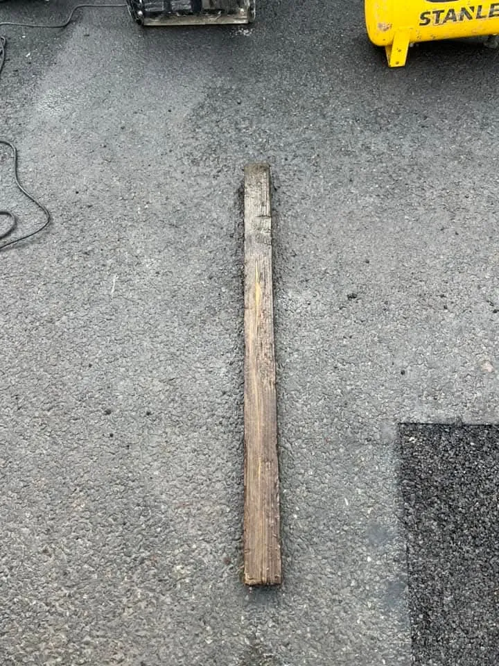 Debris (piece of wood) found during drainage unblocking or repair.