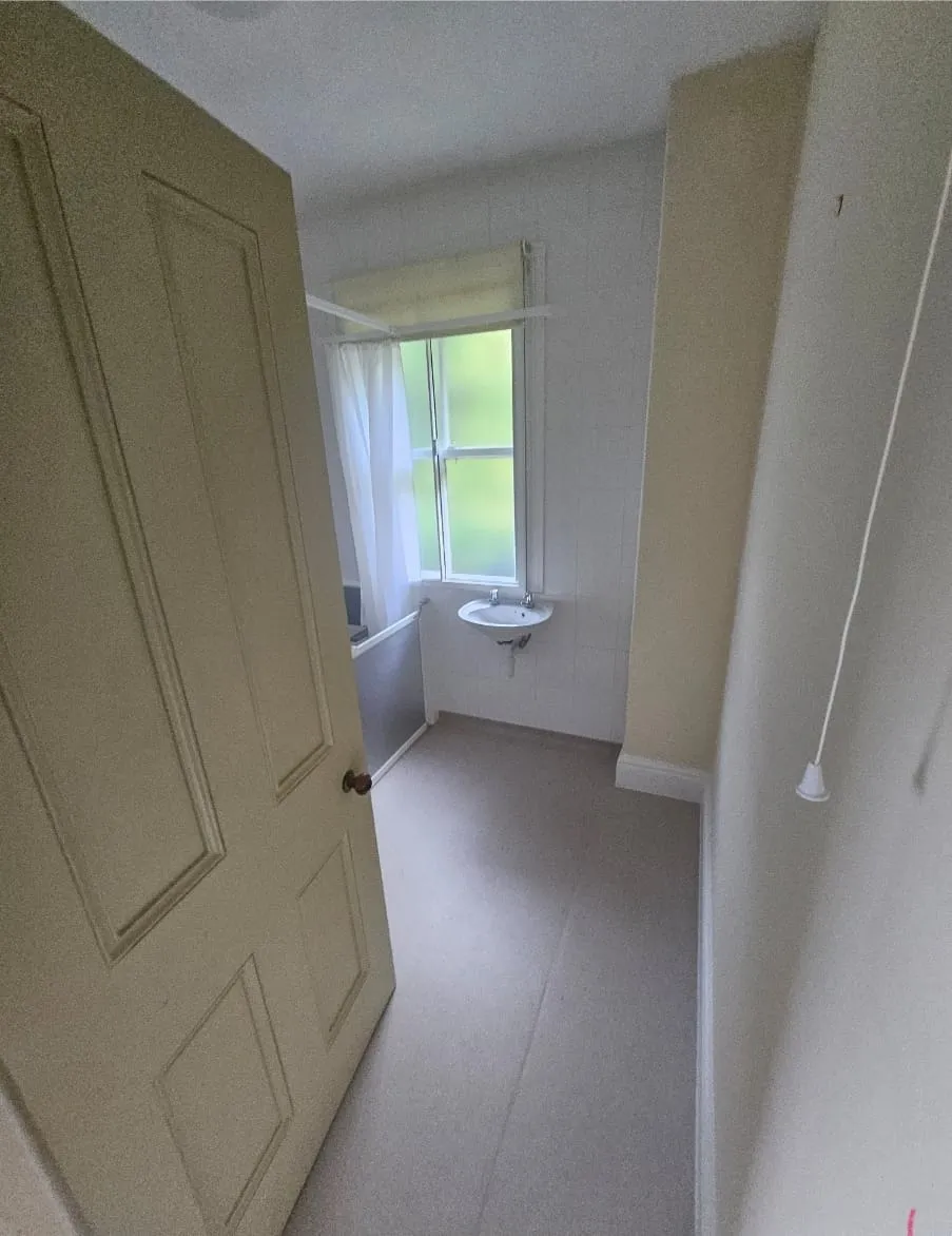 A picture of a cleared, empty bathroom in a property after a house clearance.