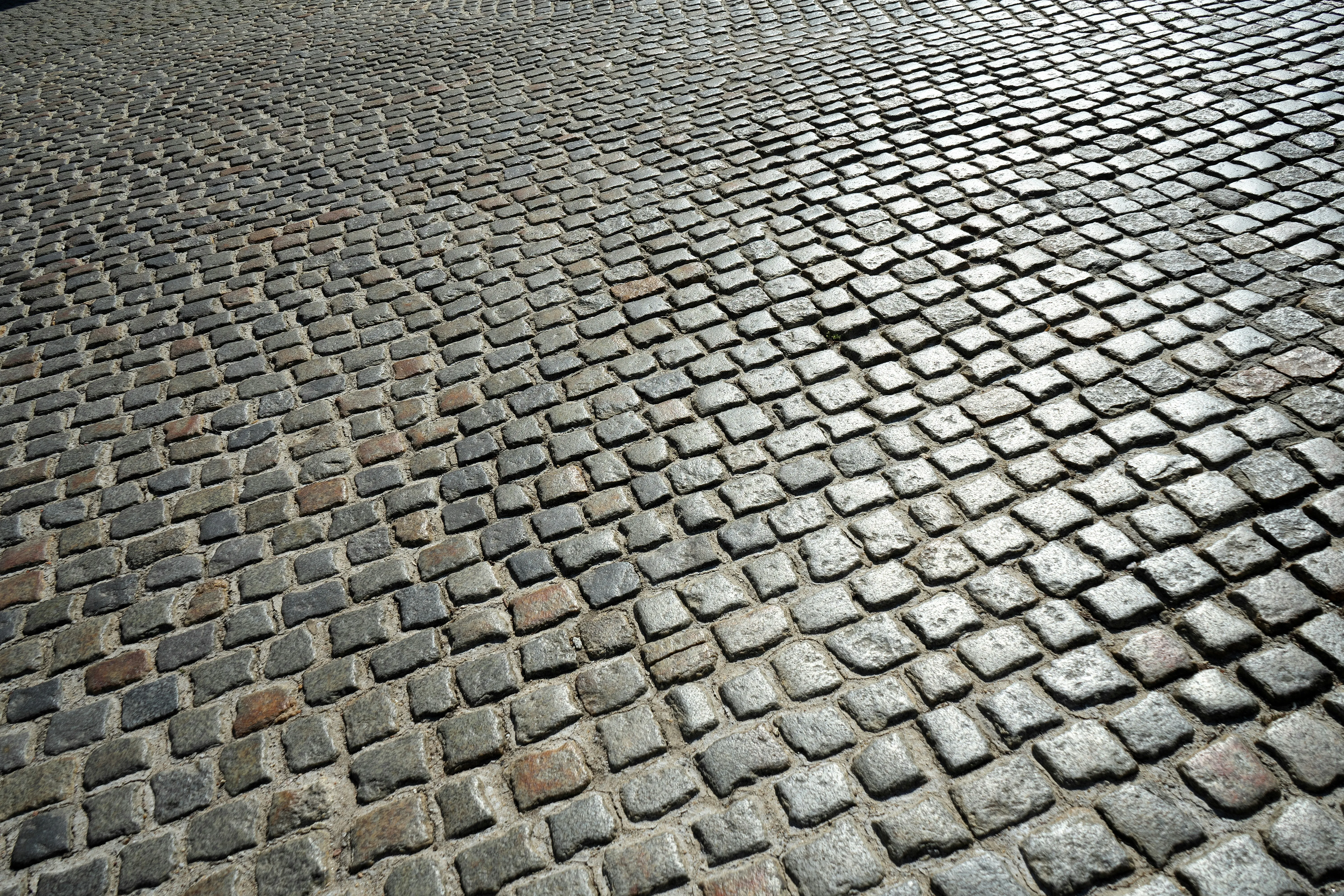 Textured pattern of grey cobble paving stones