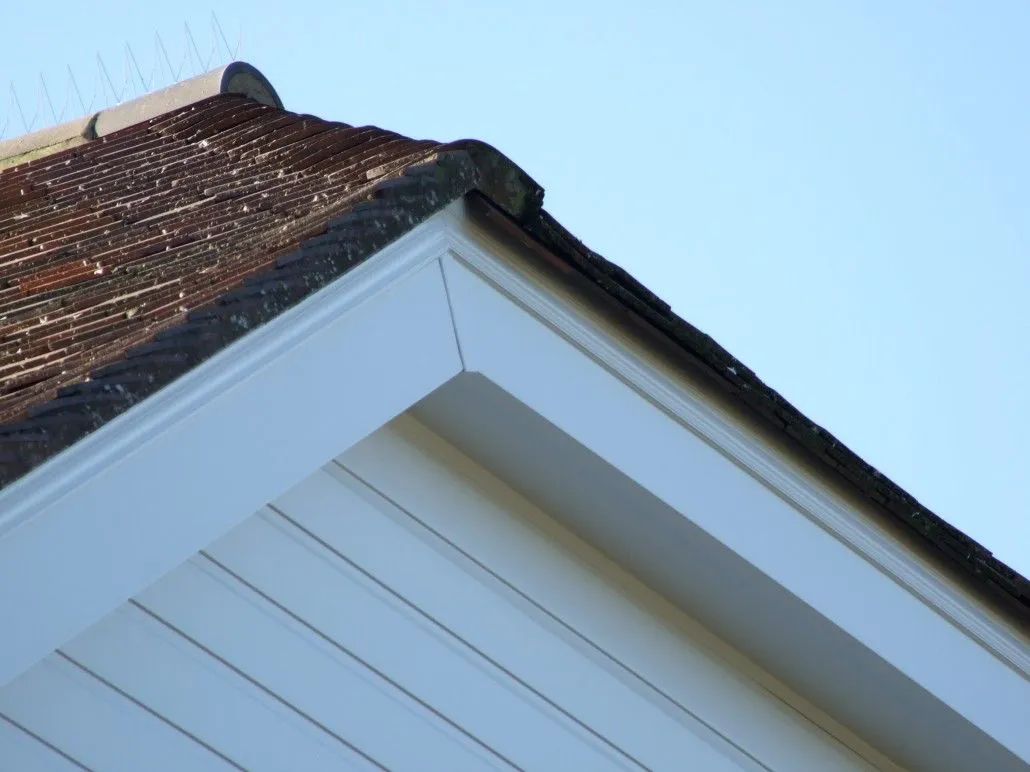 Close-up of roof corner with new white fascia and soffit