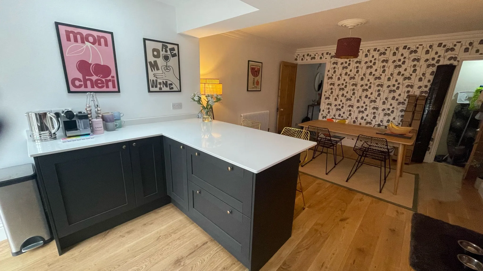 Modern bespoke kitchen installation in Hatherley by DP Carpentry & Building LTD, showcasing dark cabinets and white countertops.