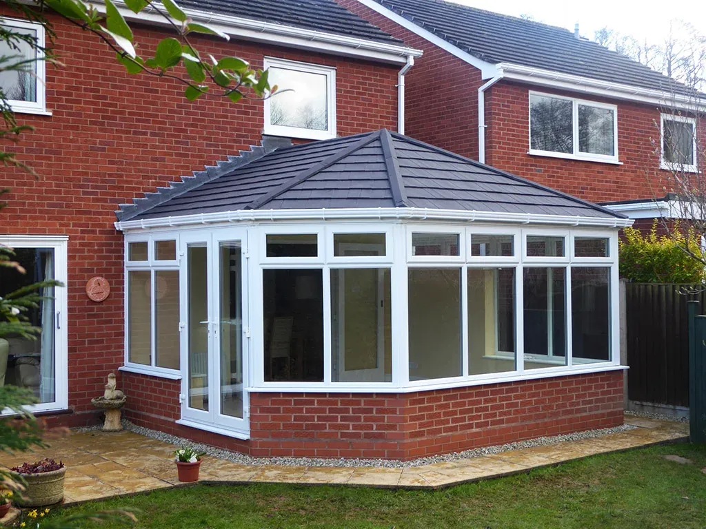 Tiled conservatory roof replacement on a red brick house by Conservatory Roofs 4 You