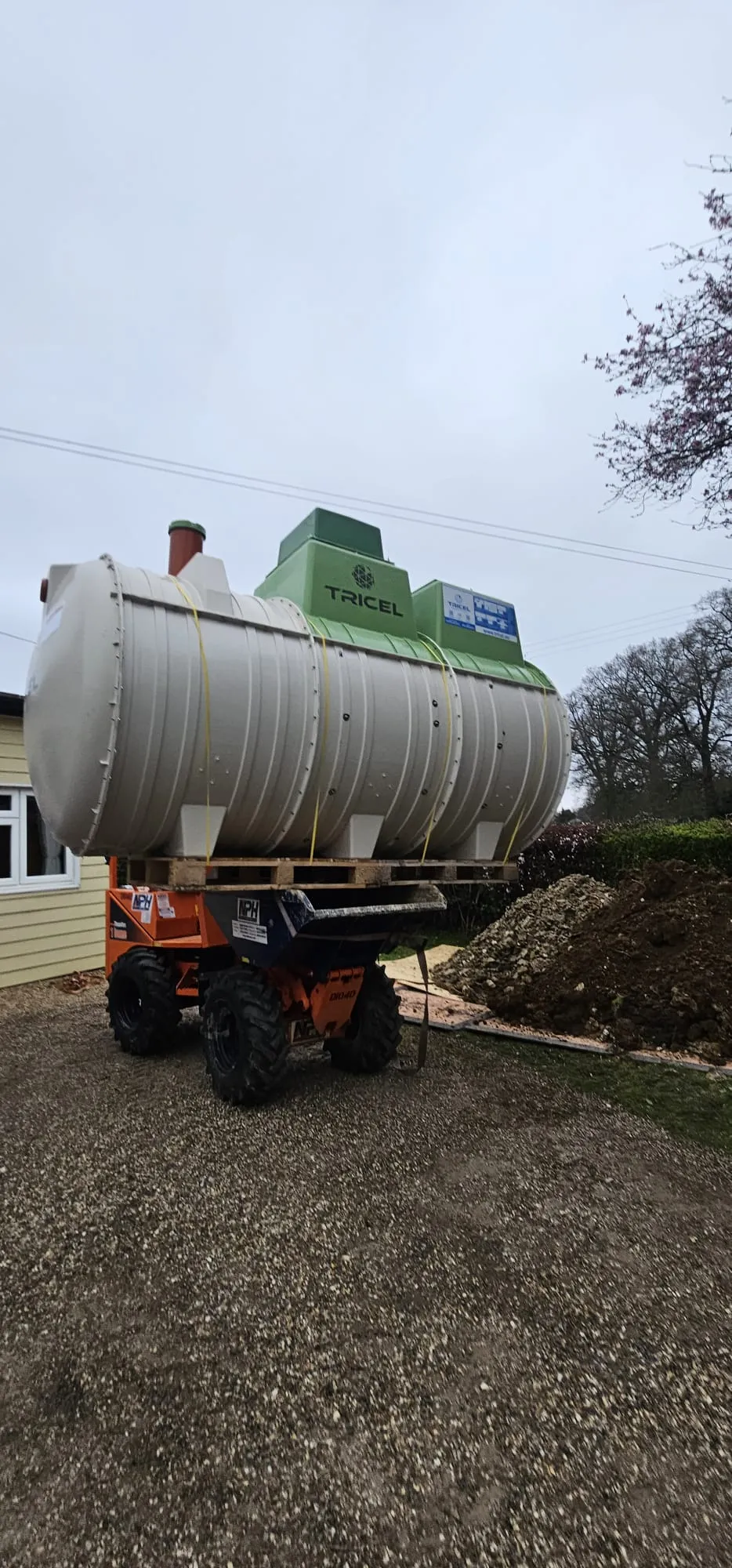 Tricel sewage treatment plant being delivered on a dumper for installation