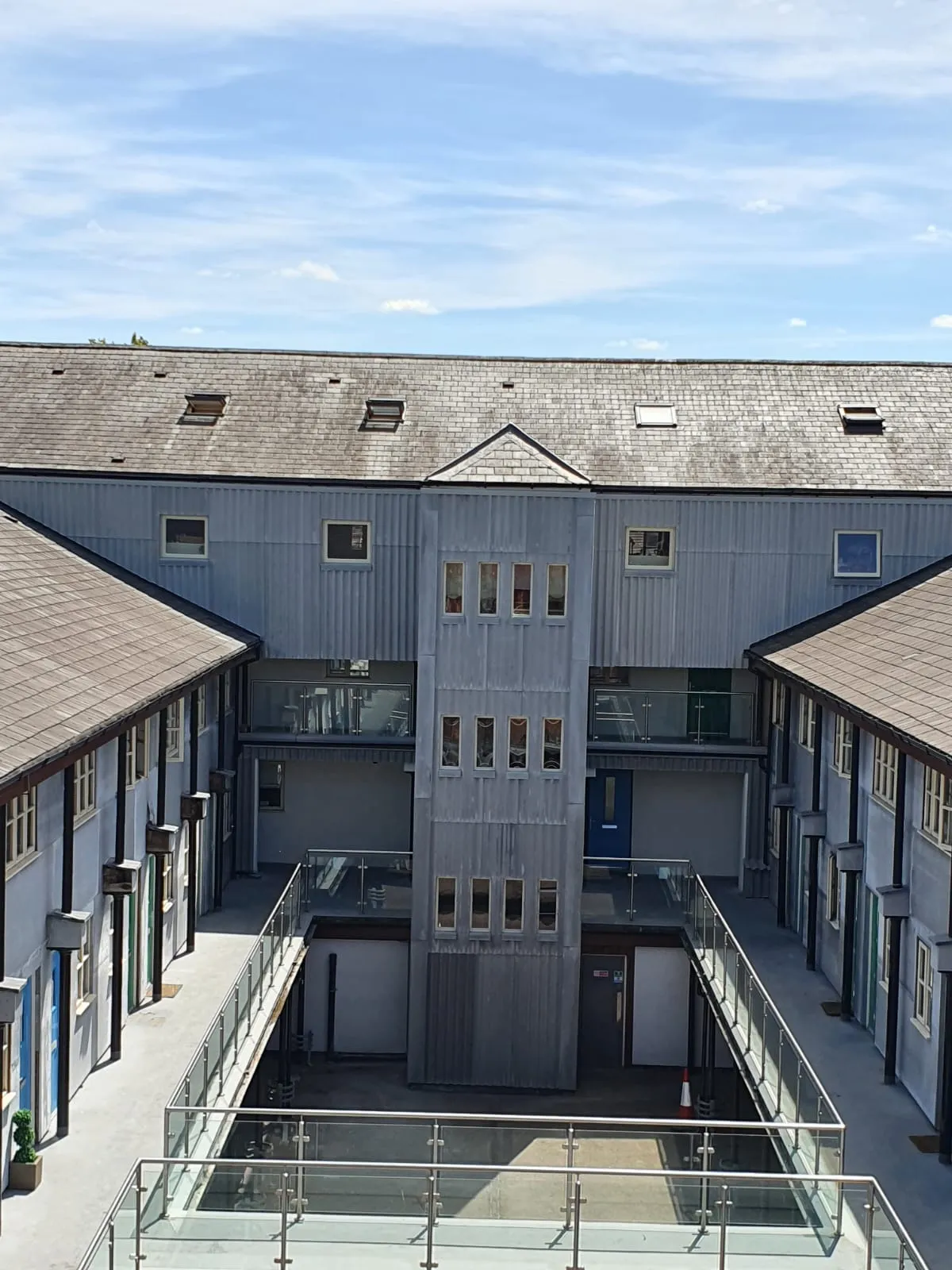 Modern building with multiple pitched roofs and Velux windows/skylights