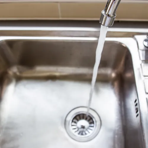 Water running into a sink drain