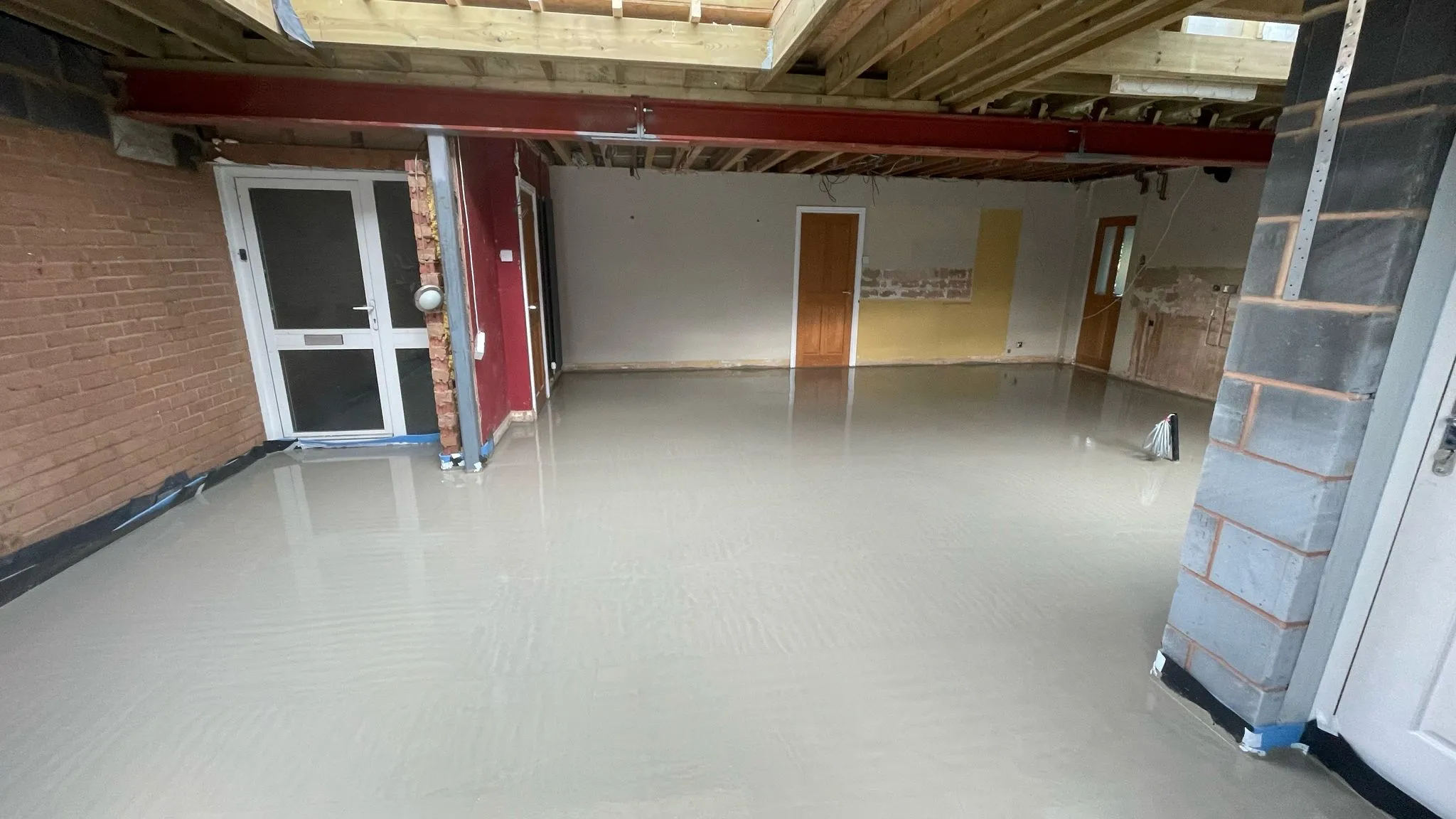 Professional liquid screed floor installation during a home renovation project in Cheltenham