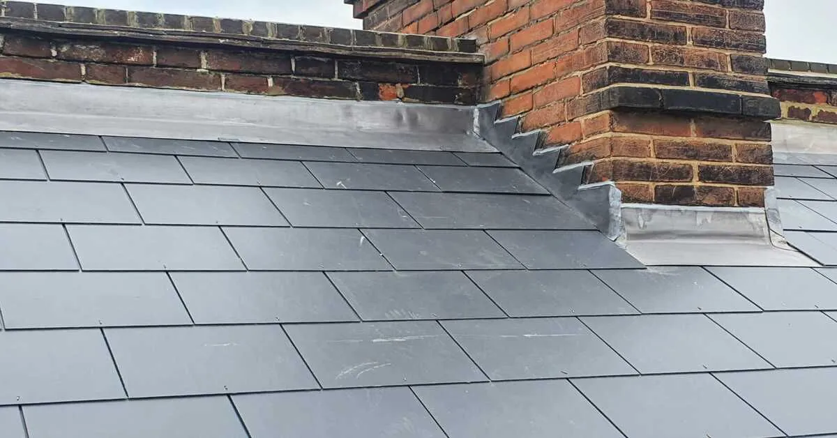 Close up of new lead flashing around a chimney on a tiled roof