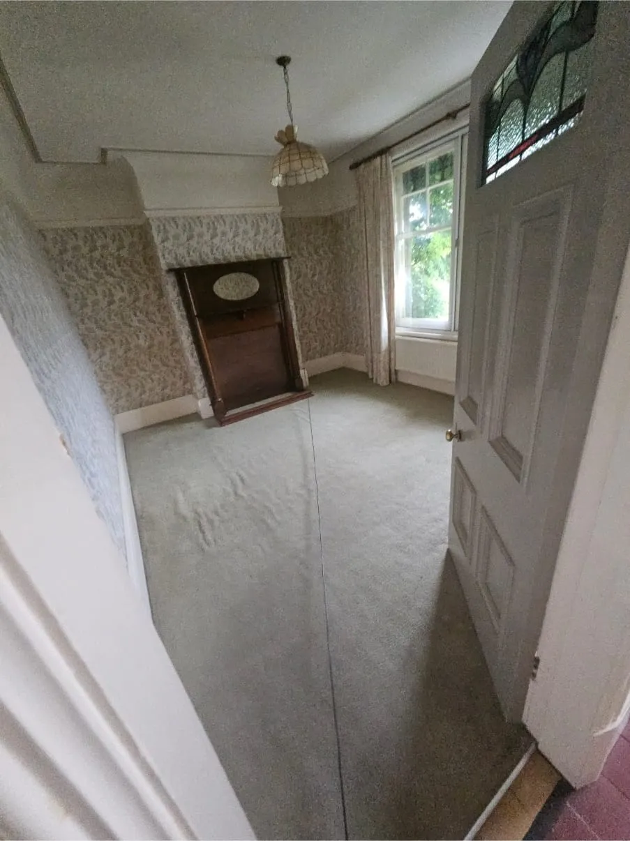 Empty room in an old house, ready for a full house clearance or end-of-tenancy clean in Llandudno, North Wales.