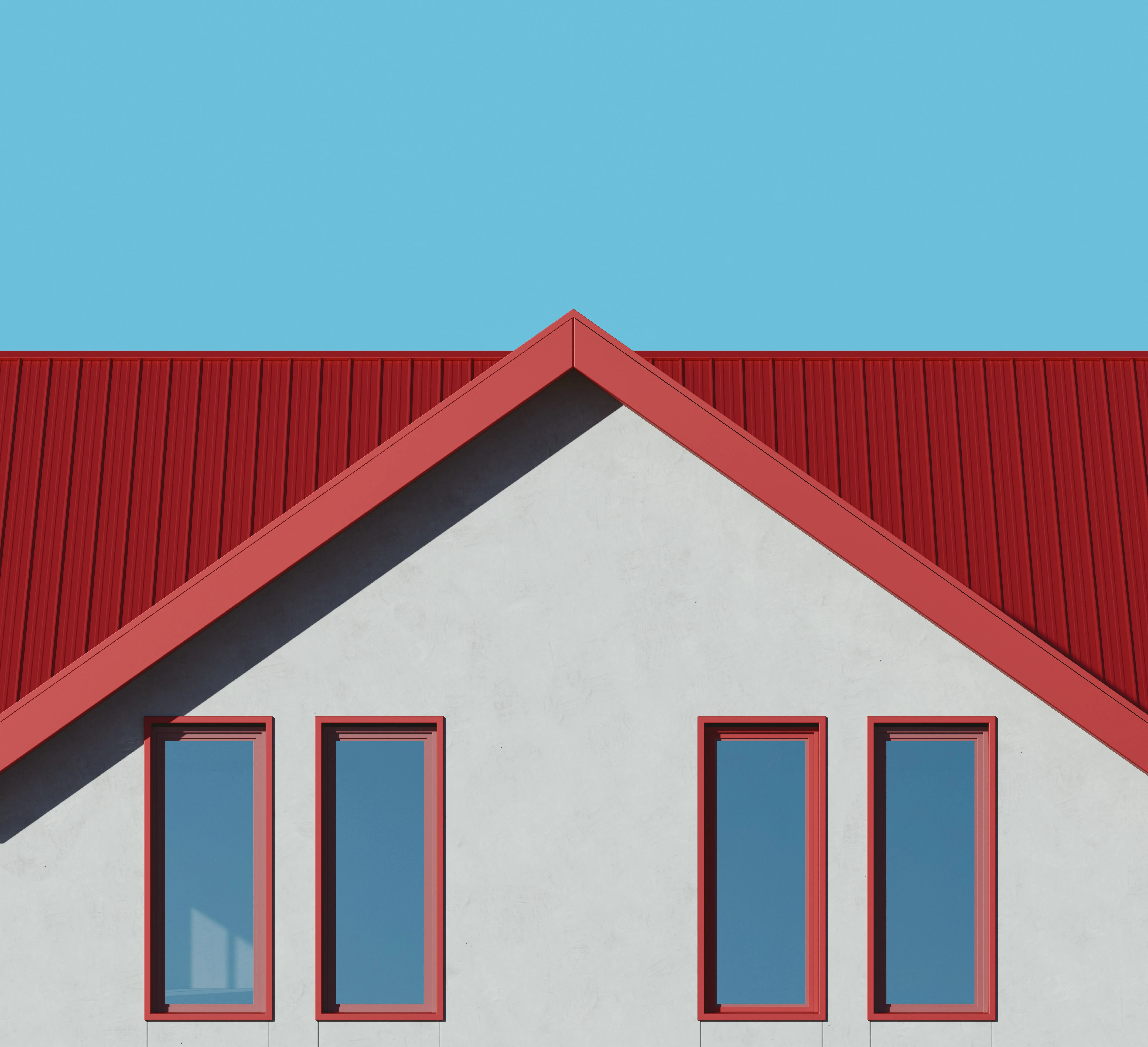Close-up of a modern building with a bright red pitched metal roof and white walls, ideal for metal roof installations.